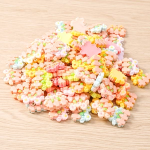 Macro shot of mixed resin flower charms with metal loops for DIY jewelry making kits