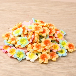 Macro detail of mixed color resin plumeria flower charms with silver metal loops