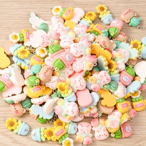 Detailed macro view of colorful resin charms including sunflower, bunny and flower pendants