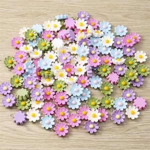 Macro shot of colorful daisy charms with metal rings for DIY jewelry and crafts