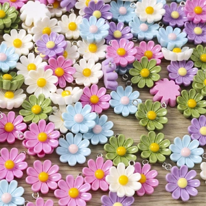 Detailed macro view of mixed colorful resin daisy flower charms for DIY jewelry making