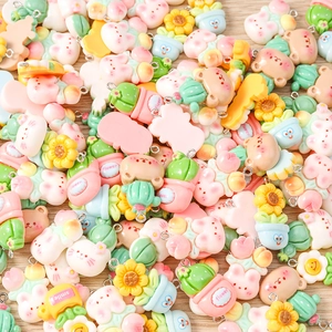 Macro shot of colorful resin cartoon charms with metal loops for DIY jewelry making