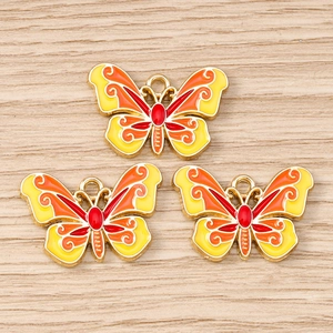 Detailed close-up of colorful enamel butterfly charms for DIY jewelry making