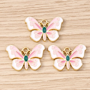Pink and white butterfly charms with gold metal edges and green gems for DIY jewelry making