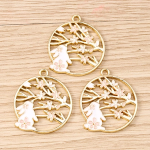 Detailed close-up of golden rabbit flower pendants for DIY jewelry making accessories