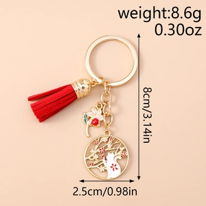 Macro view of Japanese lucky cat and cherry blossom pendant with red tassel keychain