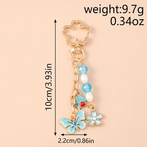 Detail view of floral butterfly keychain with blue enamel charms and size specifications