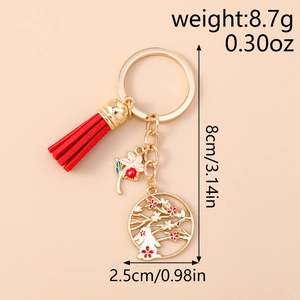 Detailed view of traditional Chinese style keychain with red tassel and rabbit floral charm