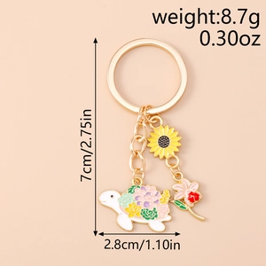 Detailed view of alloy keychain with sunflower and colorful enamel turtle pendant