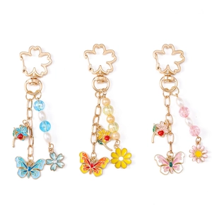 Colorful floral butterfly keychain set with pearls and cherry blossom clasp on white background
