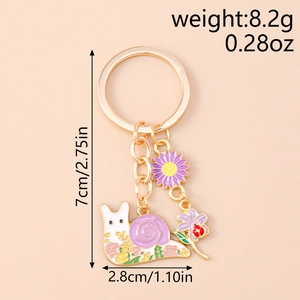 Detail of snail and flower keychain with dimensions 7cm by 2.8cm and 8.2g weight