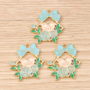 Detailed macro view of three enamel flower rabbit alloy charms for DIY jewelry making