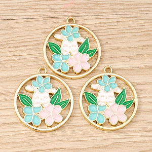 Detail view of hollow enamel flower wreath rabbit charms for DIY jewelry making