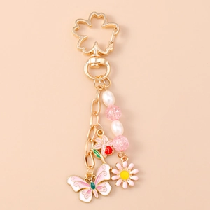 Detail of flower keychain with cherry blossom hook, pink butterfly, and pearl bead chain