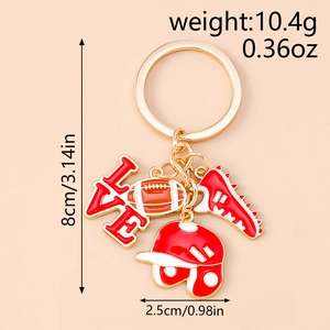 Close-up of golden sports keychain with rugby helmet, shoes and LOVE letter charm