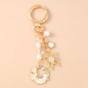 Detailed view of butterfly keychain with colorful pearls and enamel floral ring charm