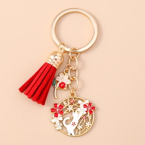 Exquisite Chinese style keychain featuring a red tassel, flower charm, and cat pendant