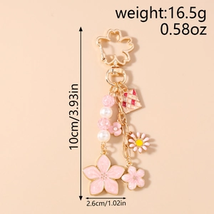 Pink enamel cherry blossom keychain with size dimensions and weight info, 10cm length