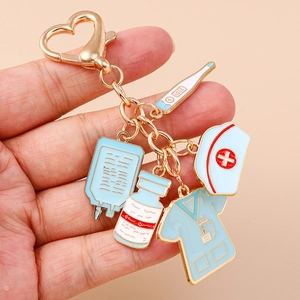 Detailed medical keychain with nurse hat, thermometer, and scrubs charms on gold ring