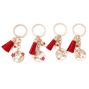 Japanese style cat and rabbit keychain charms with red tassels and gold rings