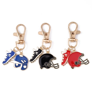 Rugby themed sports keychain set with helmet and shoe charms in blue black and red enamel