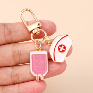 Medical theme gold keychain with pink IV bag and nurse hat pendants for bags