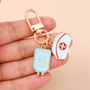 Medical theme enamel keychain with nurse hat and IV drip charms on a lobster clasp