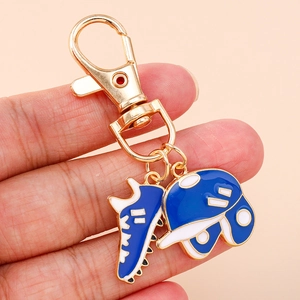Blue and white rugby helmet and shoe enamel keychain with golden metal finish and D-clasp