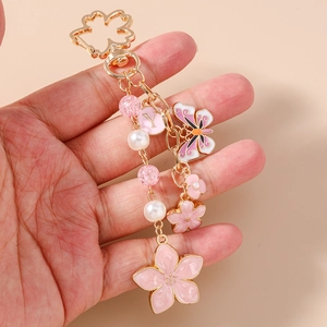 Pink sakura cherry blossom keychain with gold butterfly charm and pearl beads