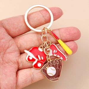 Macro view of baseball keychain with helmet, bat, and glove charms on gold keyring