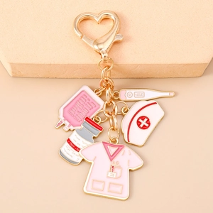 Detail of medical keychain with pink nurse uniform and drip bag enamel charms