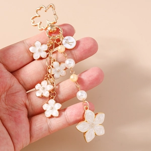 Golden cherry blossom keychain with white enamel flowers, pearls and K letter charm