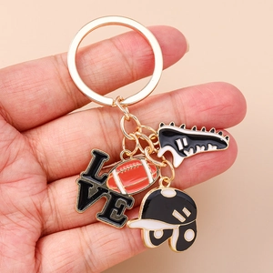 Detail of sports-themed keychain featuring rugby ball, helmet and shoe charms