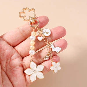 Detailed view of cherry blossom keychain with pearl beads and white rabbit charm