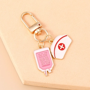 Detail of medical keychain with pink infusion bag and white nurse hat enamel charms
