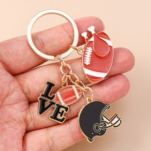 Detail of American football themed keychain featuring enamel helmet and love charms