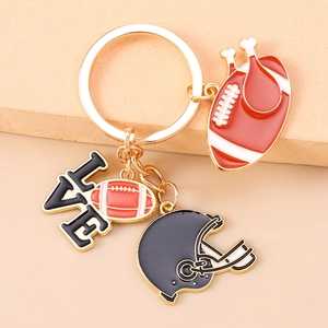 Detailed view of American football keychain with helmet, LOVE charm, and ball pendants