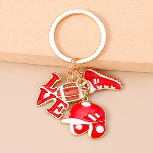 Detailed close-up of gold keyring with enamel American football and sports charms