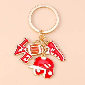 Detailed macro view of American football themed gold keychain with love charm and sports charms