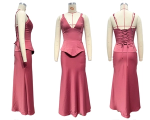 Detail view of pink satin two-piece long dress set with corset top and maxi skirt