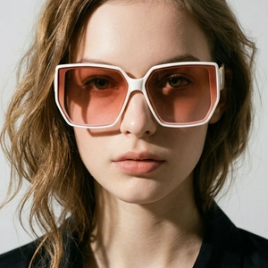 Detailed close-up of white oversized square sunglasses with pink gradient lenses on model