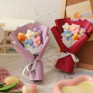 Miniature handmade crochet yarn bouquets in purple and red packaging for gift giving