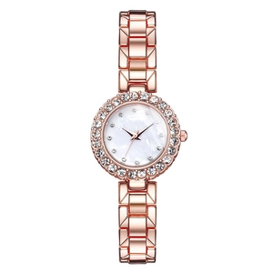 Detail view of rose gold fashion watch featuring a sparkling crystal bezel and marble dial