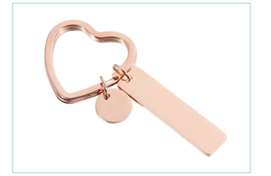 Detailed close-up of rose gold stainless steel heart ring with blank rectangle tags