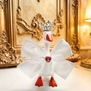 Close-up of a 7-inch mini goose statue with silver crown and pink heart gem bow