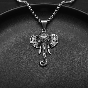 Detail shot of vintage elephant pendant with intricate wave carvings on square pearl chain
