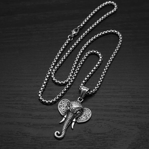 Macro view of vintage stainless steel elephant head pendant with intricate box chain detail