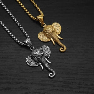 Detailed macro view of vintage elephant head pendants in gold and silver steel finish