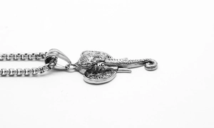 Close-up of vintage elephant head pendant with antique finish on stainless steel chain