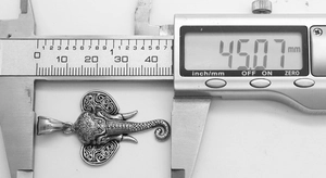 Detail showing the 45mm width measurement of the vintage steel elephant pendant